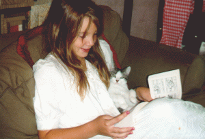 Dr. Sanders at 10 years old, reading Garfield to Frisco